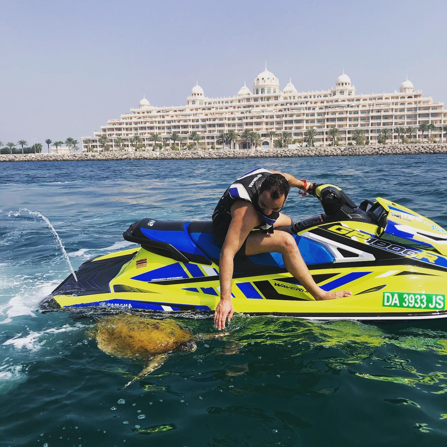 Man enjoying jet ski water sports in Dubai near the coastline. Follow the Ride in Dubai packing checklist for fun beach water sports and safe water sports in Dubai.