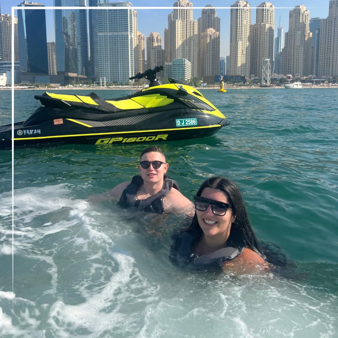 Couple in water protecting their skin with a water resistant sunscreen.