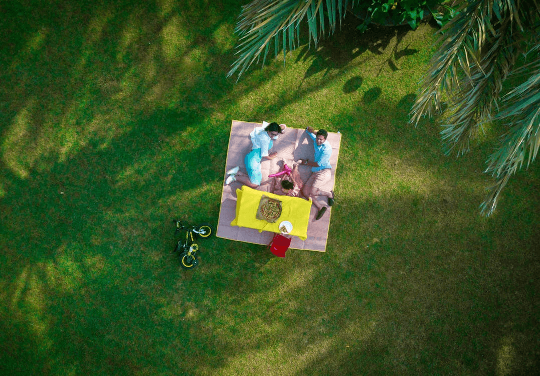 A family enjoying a picnic in a park in Dubai, a relaxing way to spend quality time together outdoors.