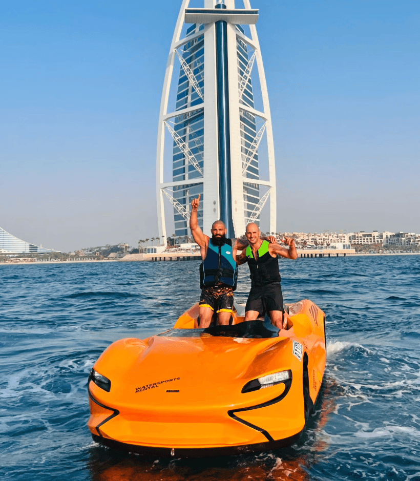 Two men enjoying a jet car ride near Burj Al Arab in Dubai, capturing skyline views and the thrill of this unique water adventure.