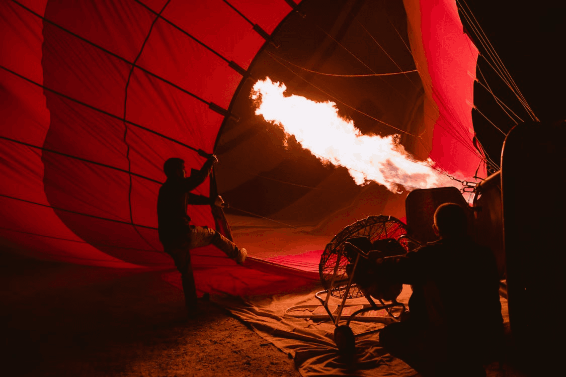 Hot air balloon being inflated in the Dubai desert before take-off.