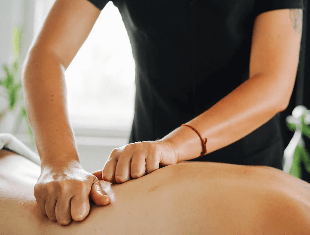 Massage therapist performing a back massage, as a relaxing birthday spa treat in Dubai.