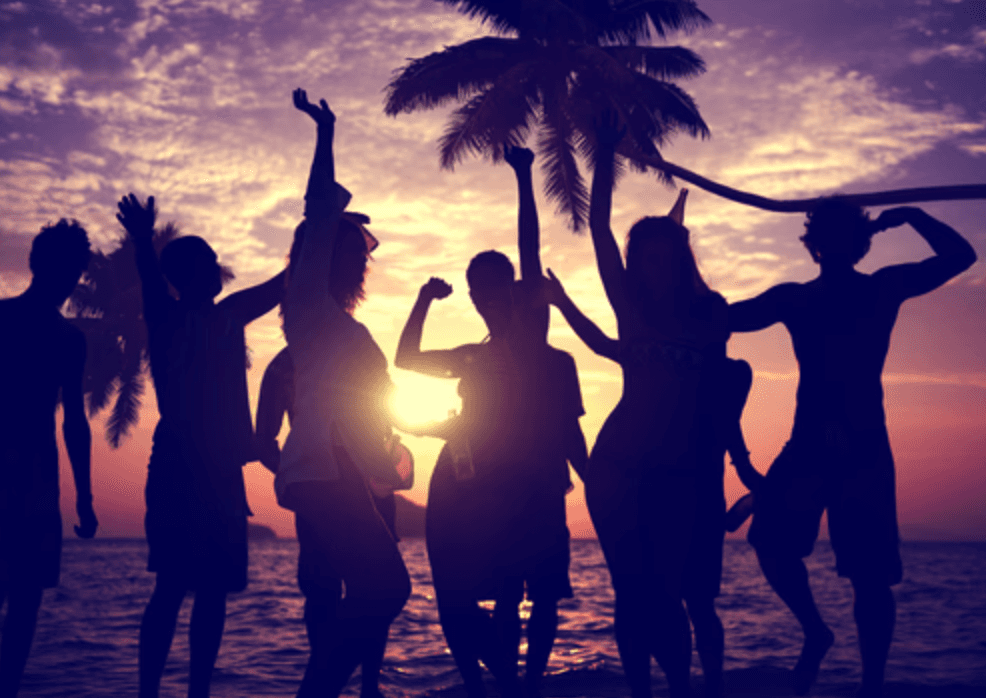 Group of friends enjoying the beach sunsets in dubai.