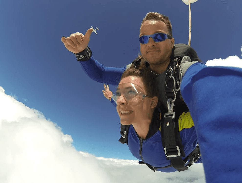 Tandem skydiving experience with a person free-falling through the sky over Dubai as part of a birthday celebration.