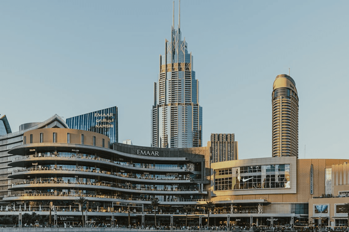 Exterior view of Dubai Mall with crowds shopping as a popular indoor summer activity.