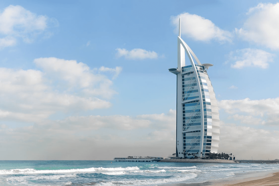 Burj Al Arab with waves along the Dubai coastline during summer.