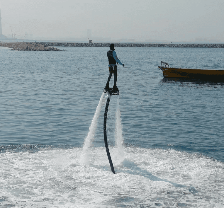 Person flyboarding above the sea with water jets in action, captured during Ride in Dubai’s signature flyboarding session for water activities in Dubai