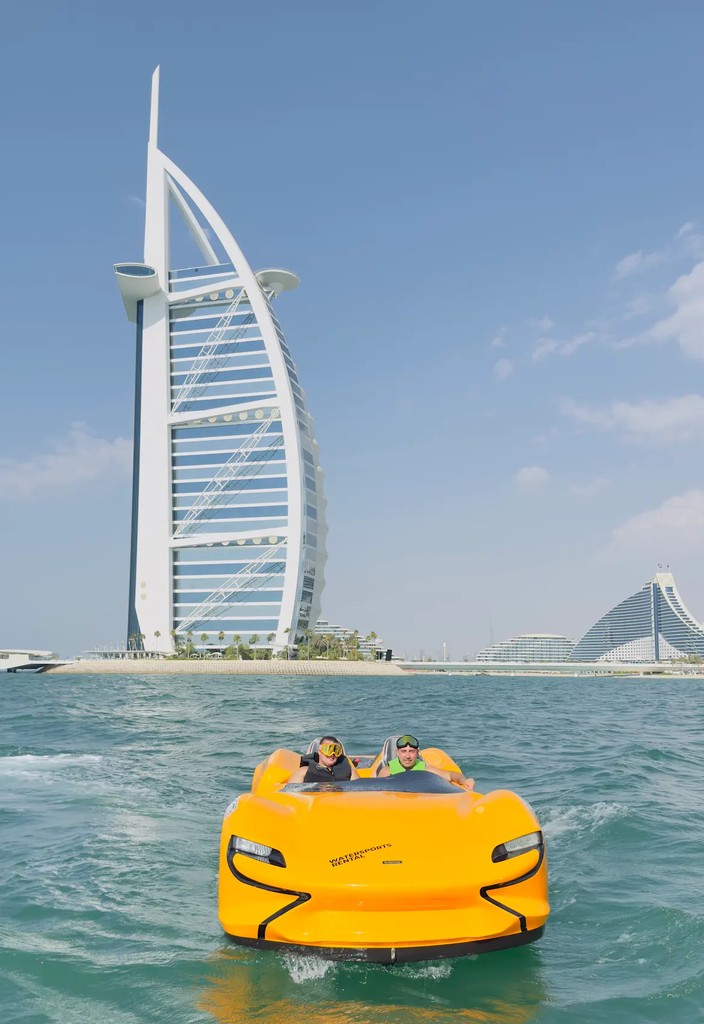 A father and son are on an orange jet car near Burj Al Arab in Dubai, enjoying the unique water adventure experience.