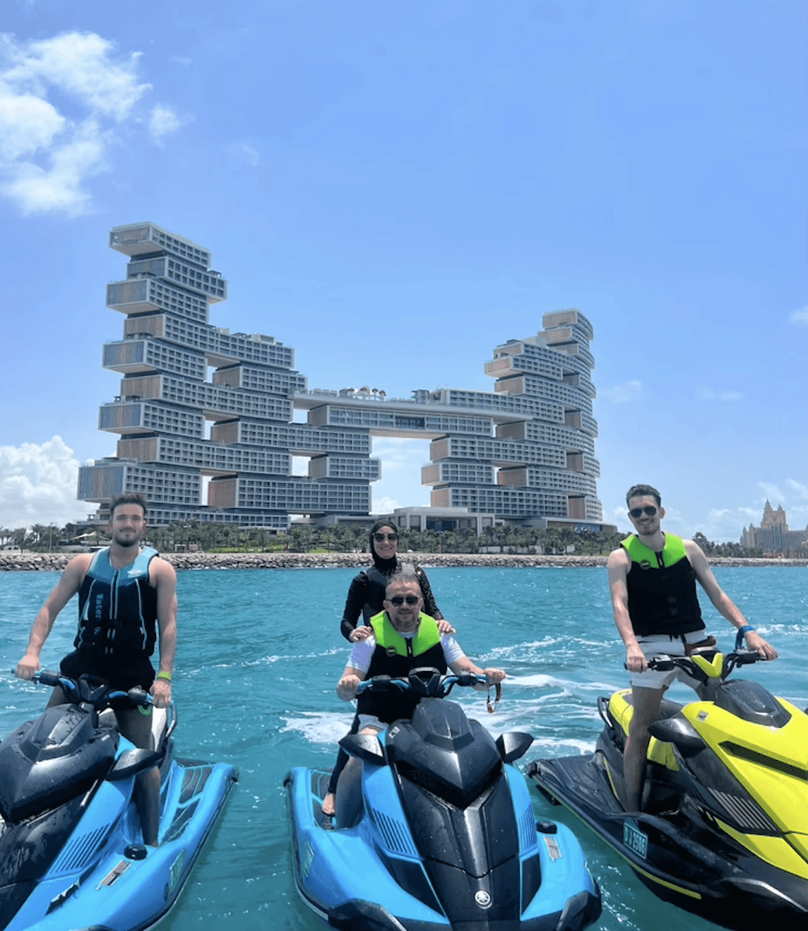 Jet ski rider cruising near iconic Dubai hotel with blue skies, capturing the excitement of a well-prepared water adventure.