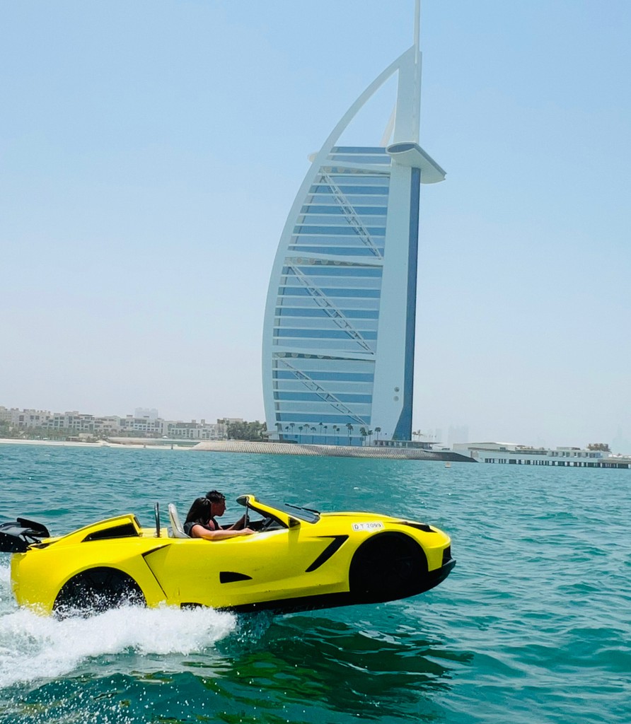 Man driving a yellow jet car near the Burj Al Arab during a 60-minute jet car ride in Dubai